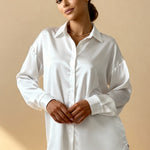 White button-front pajama blouse with point collar and long sleeves, high-low hem