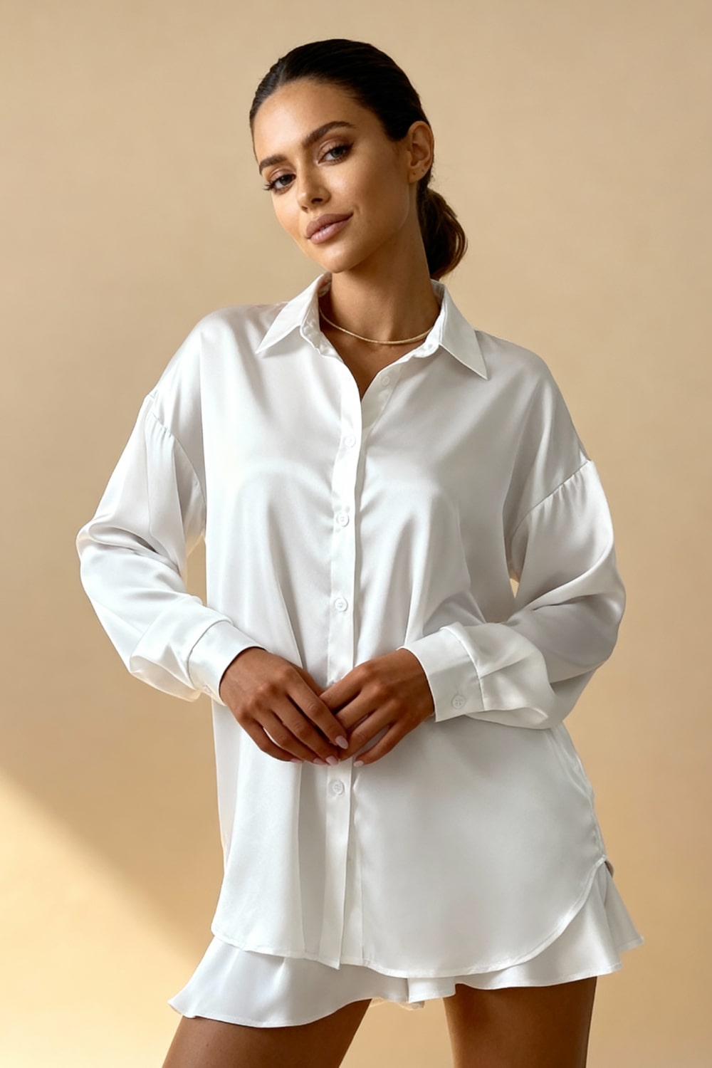 White button-front pajama blouse with point collar and long sleeves, high-low hem