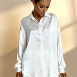 White pajama blouse with button front, point collar, long sleeves, ruffled hem