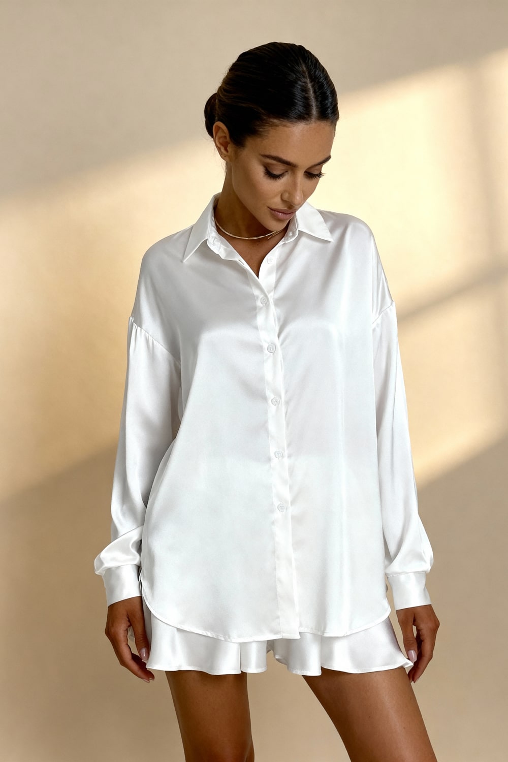 White pajama blouse with button front, point collar, long sleeves, ruffled hem