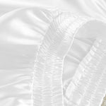 White gathered ruched detail on pajama blouse fabric near seam
