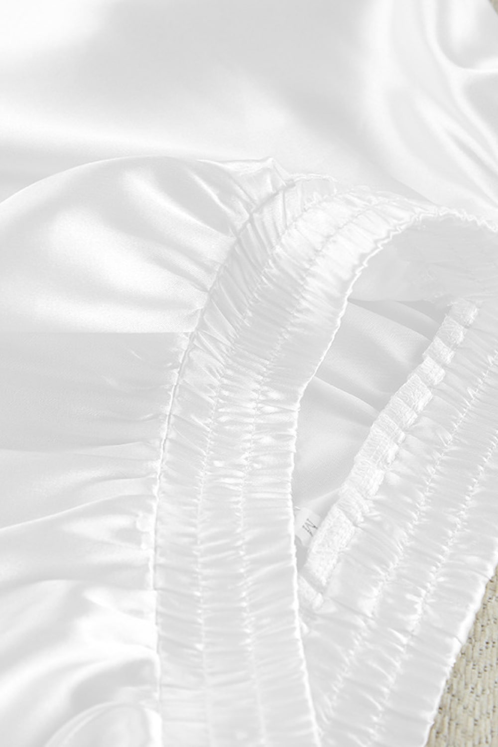 White gathered ruched detail on pajama blouse fabric near seam