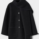 Black wool coat with integrated scarf, button front, square flap pockets and fringed hem