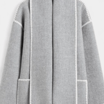 Light gray wool coat with integrated scarf, white contrast trim and patch pockets with fringe