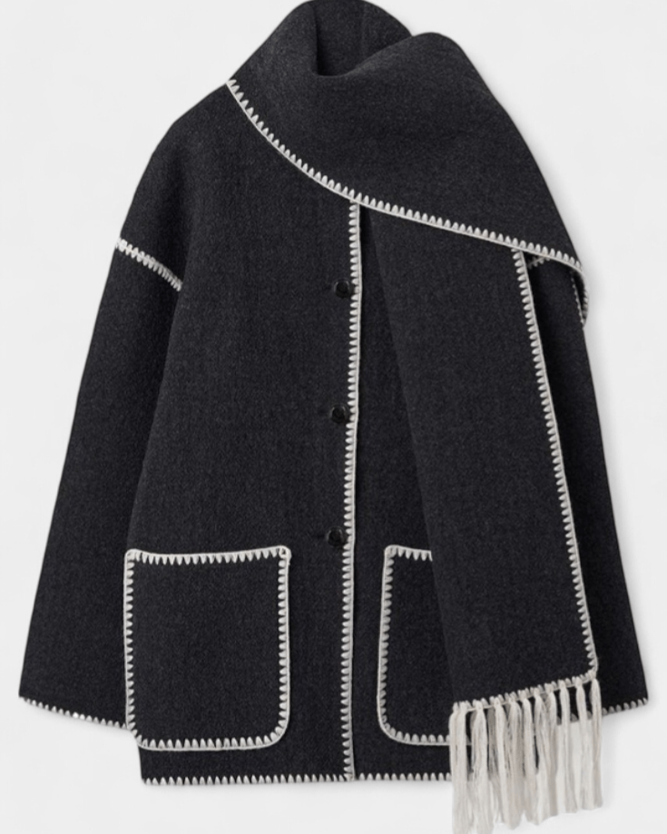 Black wool coat with integrated scarf, white contrast trim, front flap pockets and fringe