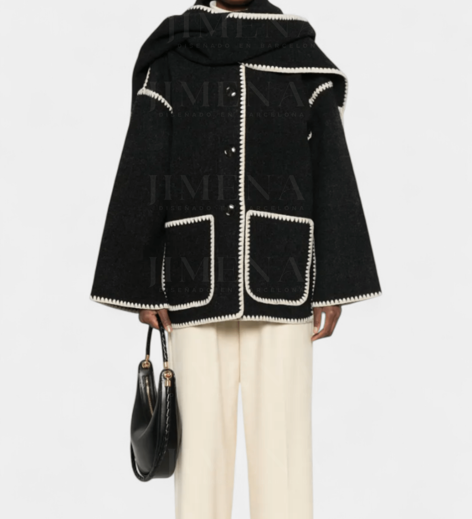 Black wool poncho-style coat with integrated scarf, white trim, flap pockets and fringe