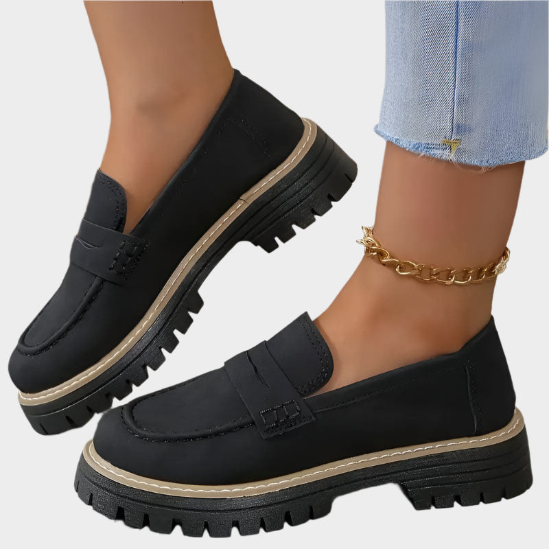 Black chunky-sole loafer moccasin with strap detail and stacked tread sole