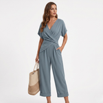 Women's blue surplice jumpsuit with short sleeves and wrap waist, cropped pants