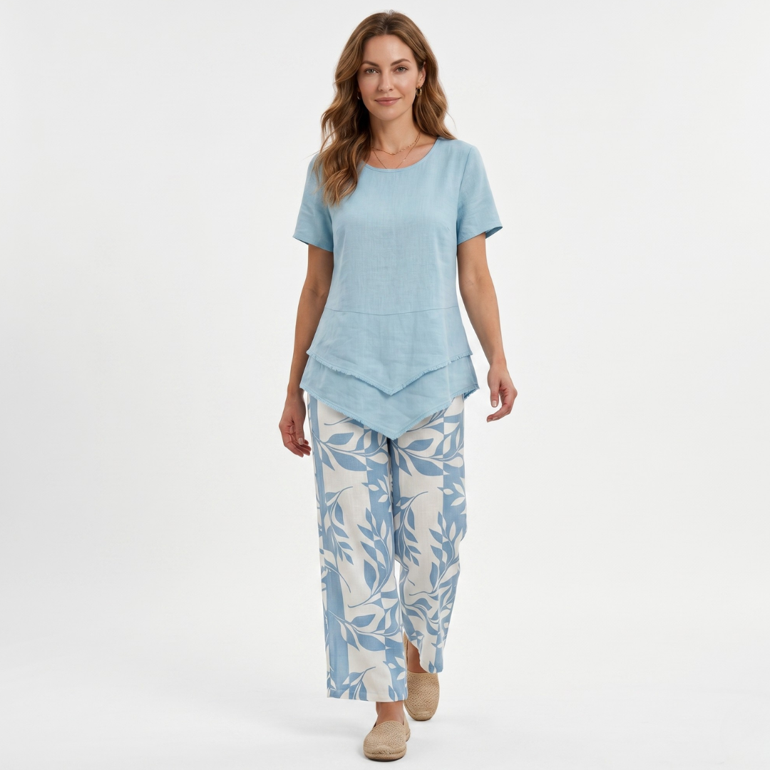 Light blue short-sleeve blouse with layered hem and matching leaf-pattern pants