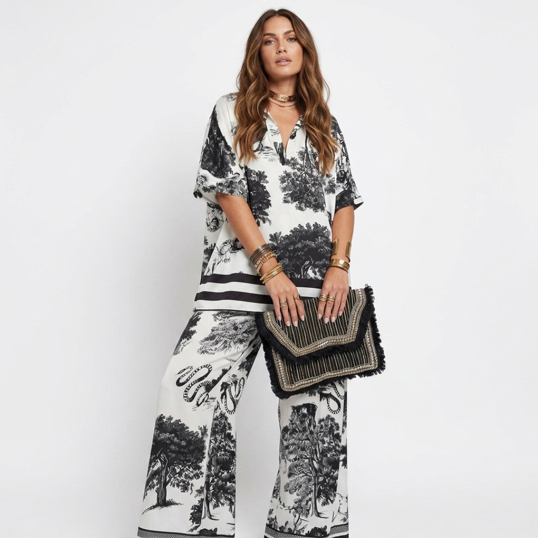 White graphic V-neck blouse and wide-leg pants set with mini handbag