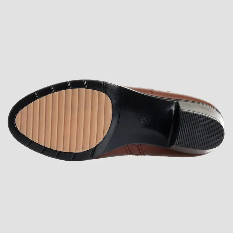 Boot sole underside in black with non-slip tread and beige inner panel