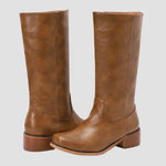 Tan tall pull-on equestrian boots with block heel and curved toe shape