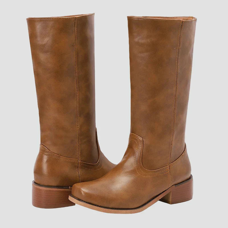 Tan tall pull-on equestrian boots with block heel and curved toe shape