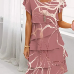 Pink patterned tiered dress with short cap sleeves and lace-trim neckline