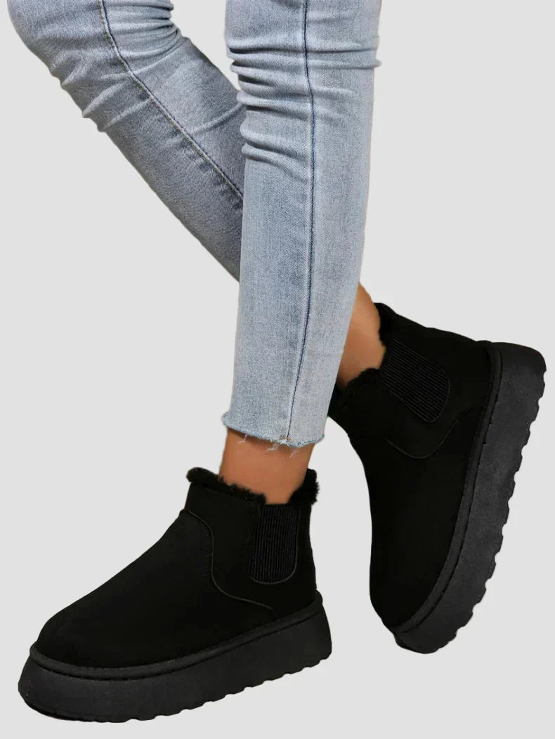 Black winter ankle boots with elastic side panels and chunky rubber sole