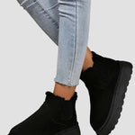 Black winter ankle boots with elastic side panels and chunky rubber sole