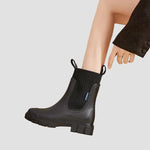 Waterproof black Chelsea boots with elastic side panels and chunky tread sole