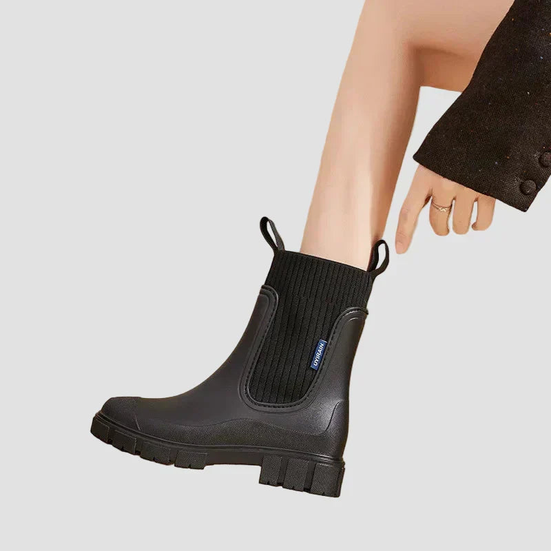 Waterproof black Chelsea boots with elastic side panels and chunky tread sole