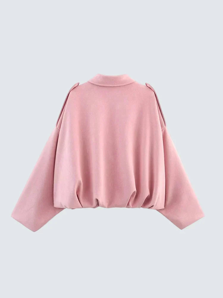 Pink short jacket with high round neckline, long sleeves and gathered back hem