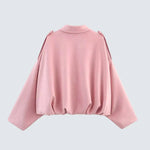 Pink short jacket with high round neckline, long sleeves and gathered back hem