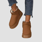 Brown suede ankle boots with plush collar lining and side seam stitching