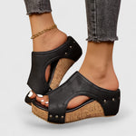 Black platform orthopedic wedge sandals with studded straps and cork-style footbed