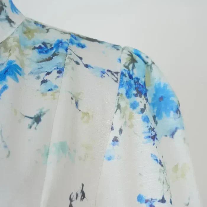 Close-up of blue floral print on white fabric with lightweight texture