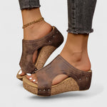 Dark brown platform orthopedic wedge sandals with studded straps and cork-style insole