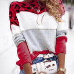 Leopard print knit pullover sweater with white and gray body and red/pink spotted sleeves