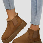 Tan brown winter ankle boots with elastic side panels and thick sole