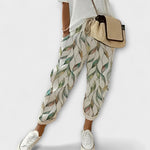 Boho tapered pants with light green leaf print, drawstring waist, elastic cuffs