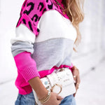 Leopard print knit pullover sweater with white and gray center panel, pink leopard sleeves