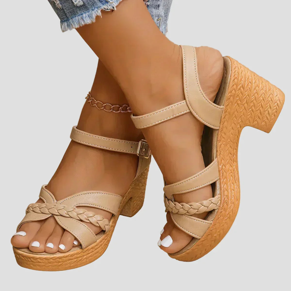 Beige platform sandals with ankle strap, braided toe detail, and chunky block heel
