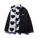 Black reversible winter jacket with smooth outer shell and heart-fleece trim