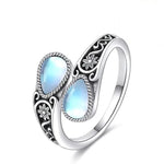 Silver-tone ring with two teardrop moonstone-like ovals and etched leaf flower design