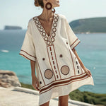 Cream beach tunic with V-neck, brown embroidered patterns, short sleeves and trim