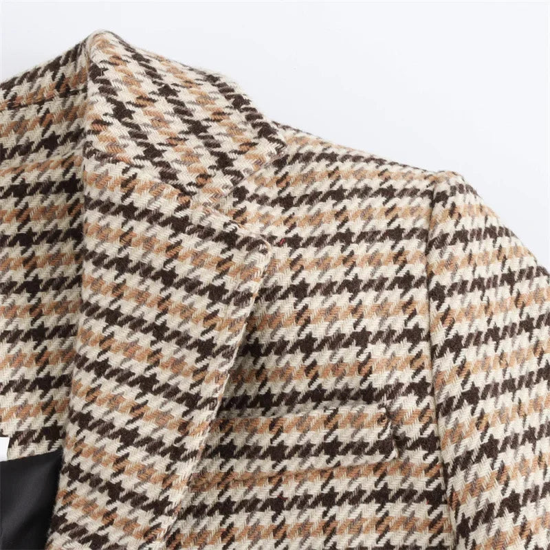 Plaid coat fabric close-up in beige, black, and brown houndstooth pattern