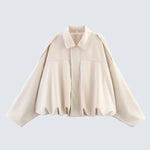 Cream short jacket with pointed collar, center zip, gathered hem and long sleeves