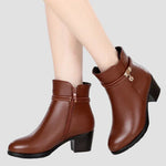 Brown ankle boots on model with faux fur cuff, decorative strap, and block heel