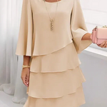 Cream layered ruffle shift dress with draped scoop neckline and tiered skirt