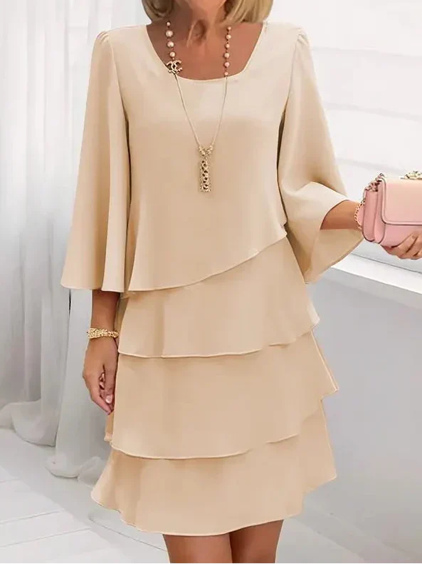 Cream layered ruffle shift dress with draped scoop neckline and tiered skirt