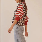 Leopard print button-front cardigan sweater with red-and-white striped sleeves