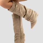 Light beige slouch tall boots with cuff buckle and block heel