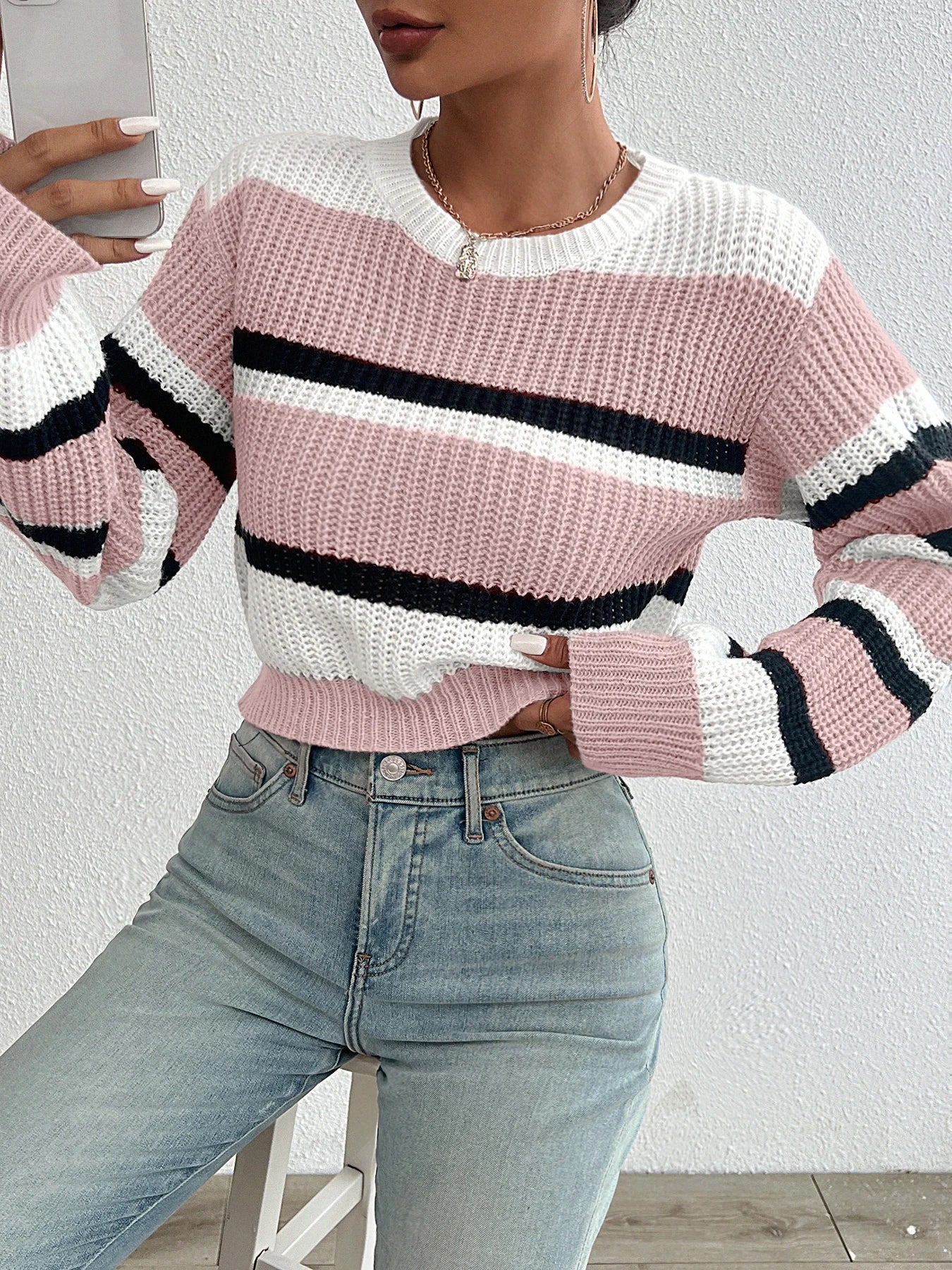 Oversized knit sweater in pink and off-white with black horizontal stripe