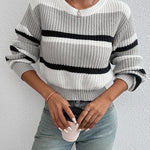 Oversized knit sweater in off-white with black horizontal stripe; crew neck and ribbing
