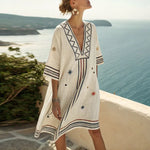 White beach tunic with V-neck and embroidered trim, relaxed fit knee-length.