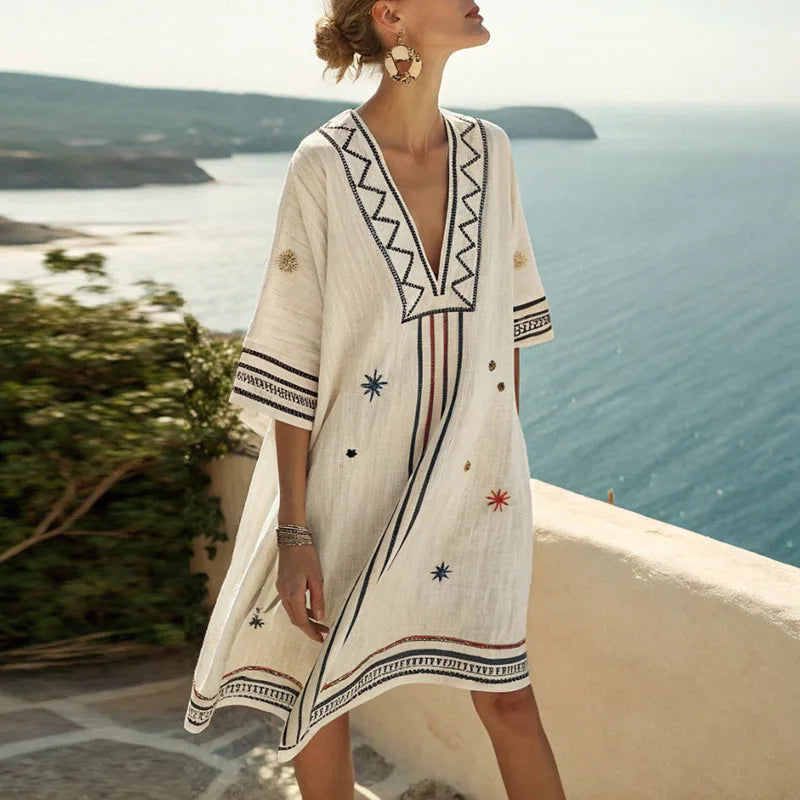 White beach tunic with V-neck and embroidered trim, relaxed fit knee-length.