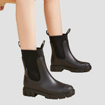 Waterproof dark green Chelsea boots with elastic side panels and chunky tread sole