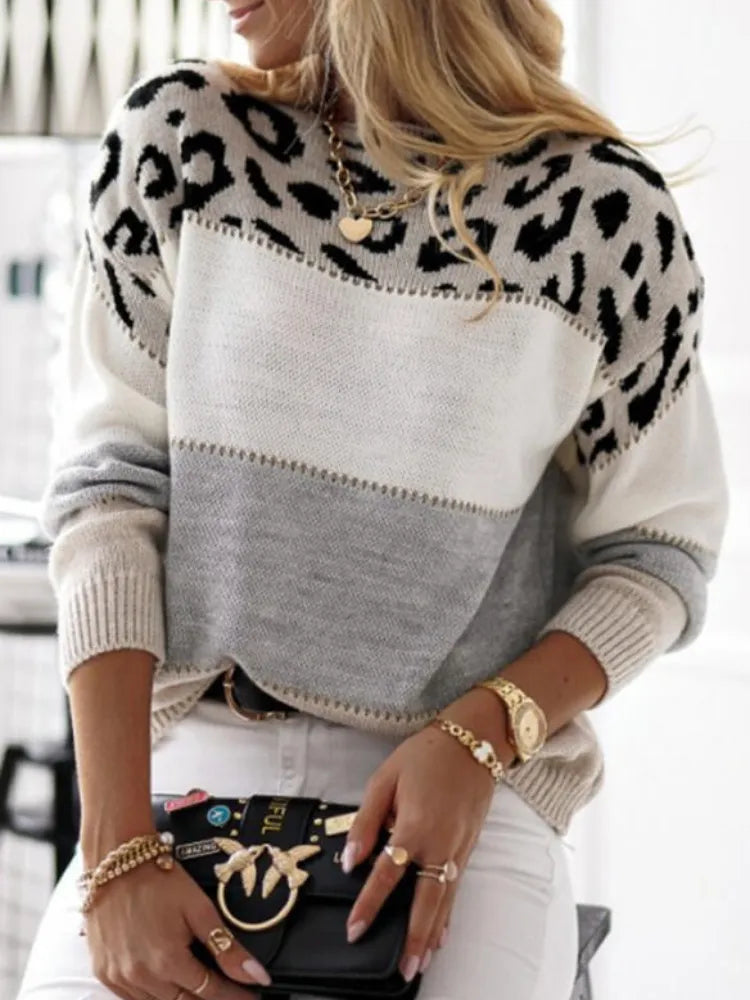 Leopard print knit pullover sweater with gray front panel and black spotted sleeves