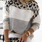 Leopard print knit pullover sweater with gray front panel and black spotted sleeves